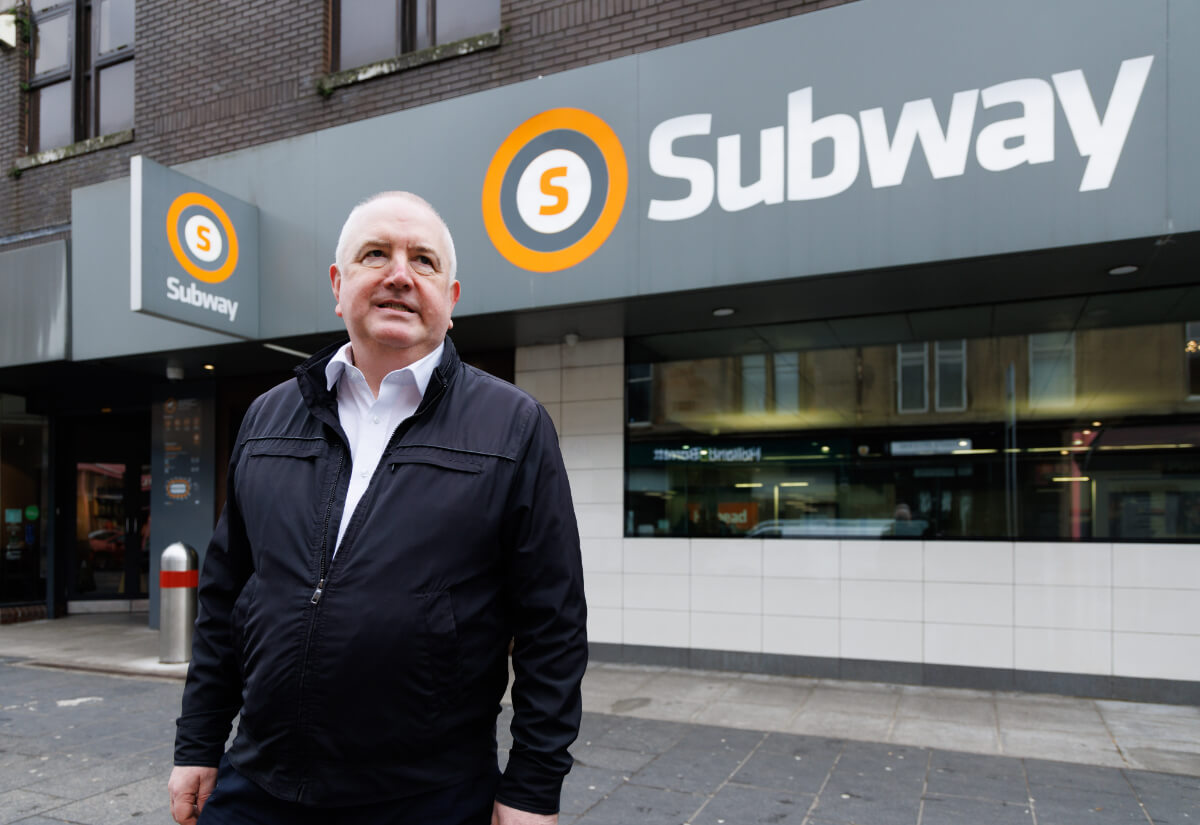 a person stood in front of a subway station